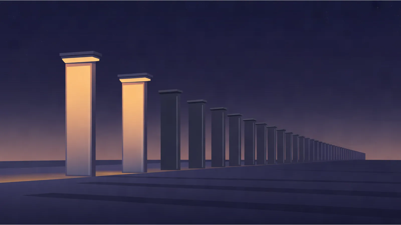 A long row of identical square-topped pillars receding across a dark plain at dusk, the two nearest glowing warm amber and every other pillar unlit.
